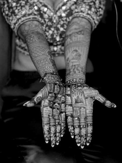 A black and white photo that emphasizes the incredible detail and coverage of this bridal mehendi.
