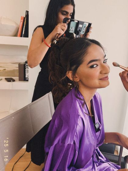 A behind the scenes shot of Anushka Sen getting her makeup done before the Cannes red carpet. I'm in the background, capturing the moment and making sure every detail is perfect.