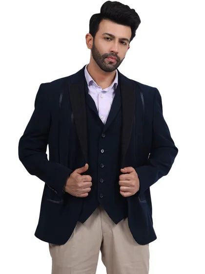 A full view of a model in a navy three-piece suit, adjusting his jacket. This classic pose conveys a sense of style and confidence, making it a strong image for any menswear brand.