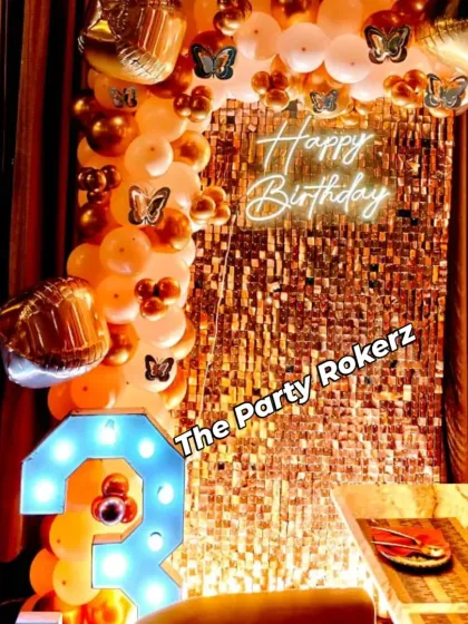 A full shot of the elegant 13th birthday setup. The combination of the sequin wall, balloon arch, and lighted number creates a perfect backdrop for photos.
