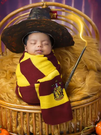 Our littlest wizard. This Harry Potter themed newborn shoot is pure magic, complete with a sorting hat, wand, and Gryffindor scarf.