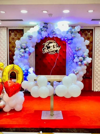 A wide shot of the 60th birthday stage, showing the scale of the decoration in a banquet hall setting.