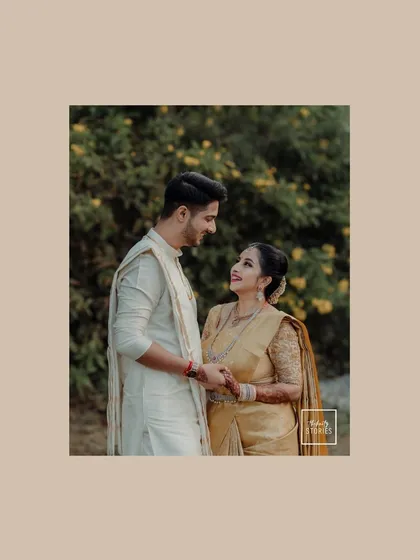 A classic portrait where the couple's loving gaze says everything. The simplicity of the pose is elevated by their beautiful traditional outfits and the natural setting.