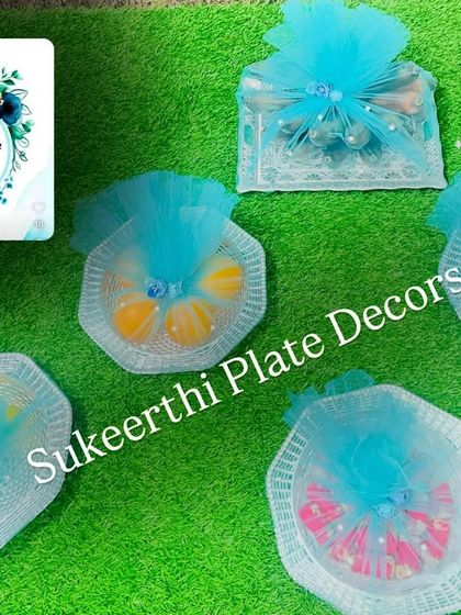 Here is another example of baby shower platters, this time with a lovely blue theme. The items are carefully wrapped in decorative netting, making them a perfect gift and addition to the ceremony.