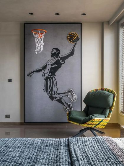 A basketball-themed mural with a real hoop creates a fun and personalized feature wall in this bedroom.