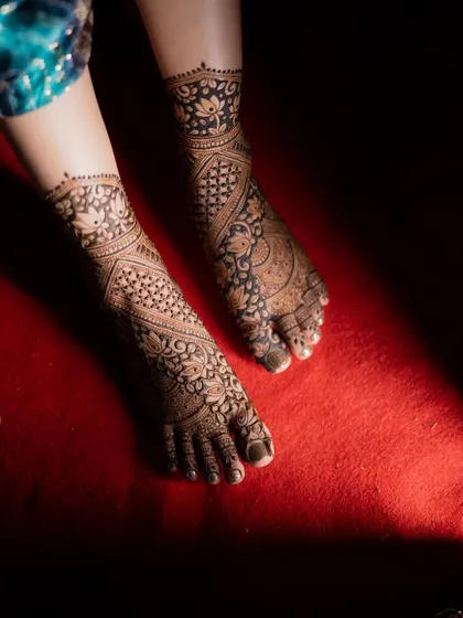 A detail shot of the bride's feet adorned with elaborate mehendi. I make sure to capture every detail, from hands to feet.