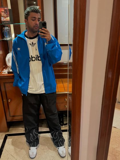 A quick mirror selfie showing off my fit before a gig. Rocking a classic Adidas look.