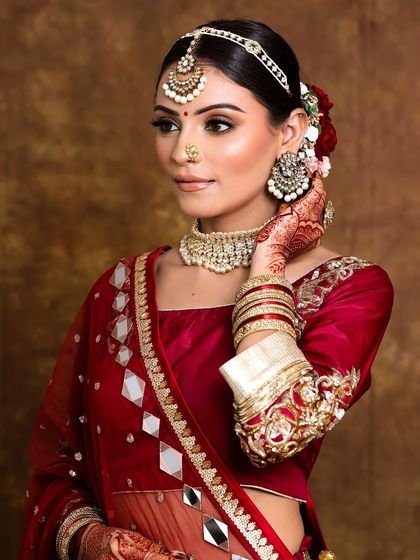 We used extensions to create this beautiful long braid for a bride with shorter hair. The hairstyle is finished with delicate flowers for a traditional touch.