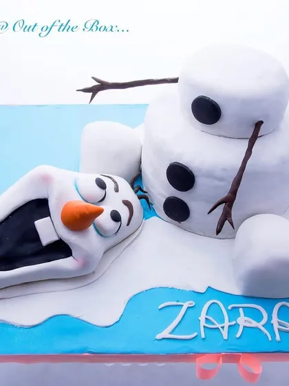 A playful melted Olaf cake, perfect for a Frozen-themed party, showing the beloved snowman in a humorous pose.
