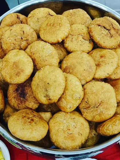 A big bowl of crispy, flaky kachoris, ready to be served for breakfast or high tea. It's a classic Indian snack that I prepare fresh for my catering events.