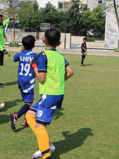 A referee provides guidance to players during a match. We ensure our leagues are professionally managed to teach players the rules and respect for officials.