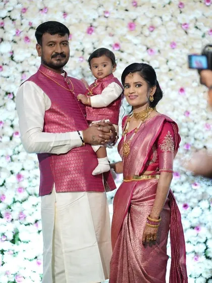 A picture-perfect family moment. I designed these coordinated outfits for a naming ceremony, with the father and son in matching pink brocade Nehru jackets over their white kurtas. Creating a unified, stylish look for the whole family is one of my favorite things to do.