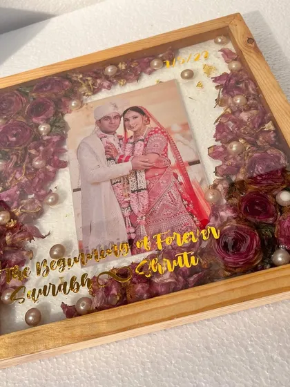 The warm tones of the teak wood frame and the preserved flowers create a very classic and elegant look. I love adding the couple's names and wedding date for that personal touch.