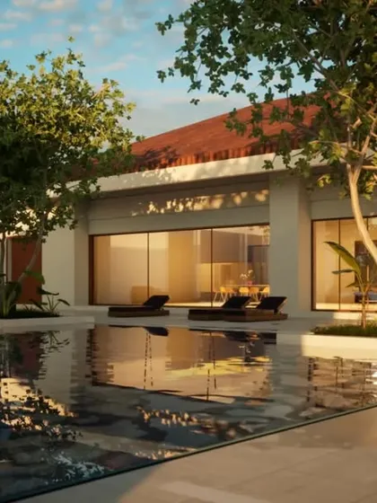 A central courtyard designed as a private oasis. The pool reflects the warm light of the setting sun, while trees planted within the courtyard bring nature into the very heart of the home.