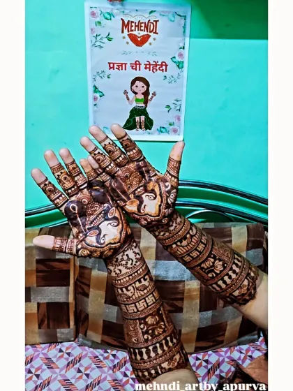 This design incorporates a Ganesha figure on the palm for blessings and good fortune. The arms feature swastika symbols and other traditional patterns, making it perfect for a wedding ceremony.
