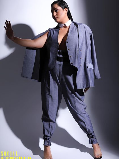 This pose highlights the unique structure of the suit from The Pot Plant Clothing. The styling focuses on clean lines and a commanding presence.