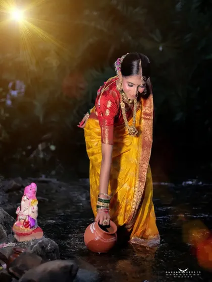A themed shot for Ganesh Chaturthi, with the model performing a ritual by a stream, creating a spiritual and beautiful scene.
