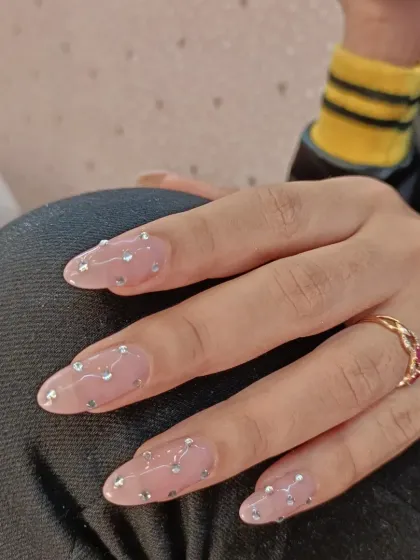 Another angle of the "diamond rain" nails, showing how the rhinestones catch the light. The long, elegant shape of the extensions makes the look even more glamorous.