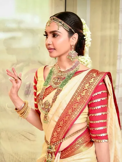 A detailed view of the South Indian bridal makeup, highlighting the intricate jewelry and the soft, glowing finish on the skin.