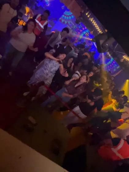 Another angle of the packed floor, showing the security keeping things orderly while the party rages.