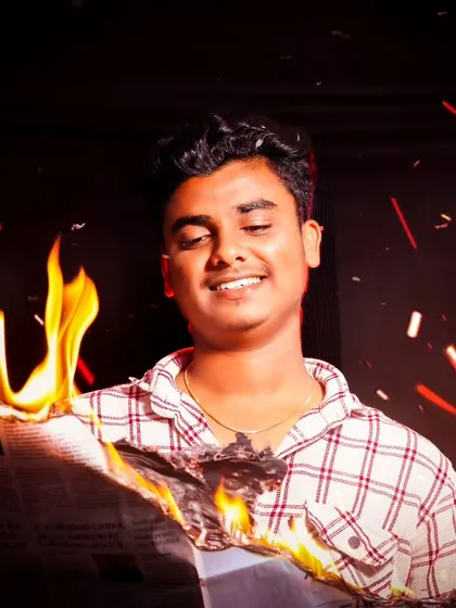 Let's play with fire, safely of course. This cinematic portrait uses a real burning newspaper and specific studio lighting to create a dramatic, warm glow and flying embers, resulting in a shot that feels like a movie still.