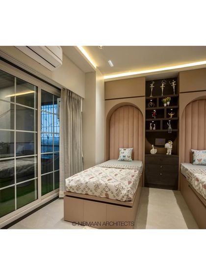 This shared bedroom has a beautiful view and direct access to the terrace. The design connects the indoor space with the outdoors, making the room feel larger and more open.