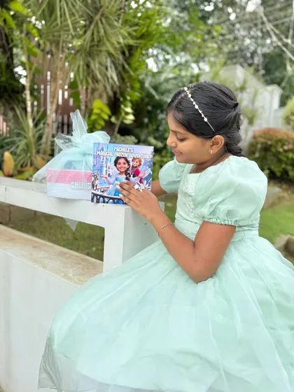 A beautiful moment captured as a young reader receives her personalized 'Frozen' storybook. Creating these cherished gifts that bring so much happiness is what I love to do.
