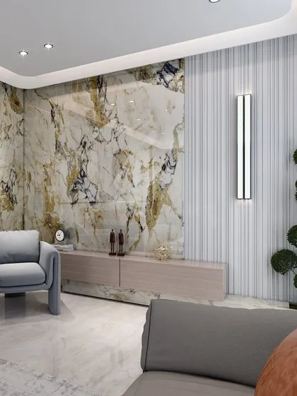 A detail shot of the TV unit area, where the marble feature wall provides a luxurious backdrop. The clean lines of the console and the soft gray armchair maintain a harmonious balance.