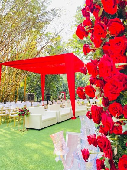 Another view of the modern red canopy and white lounge seating, a perfect blend of bold color and chic comfort.