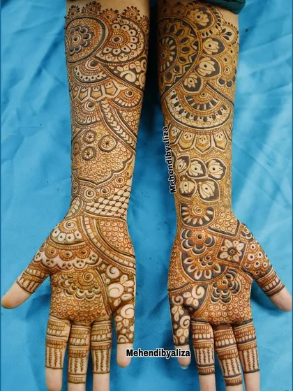 A full-hand design with intricate geometric patterns and mandalas. The symmetry and precision in this design are what make it stand out.