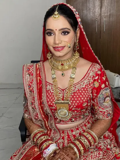 Mansi's bridal look was a beautiful blend of traditional and modern. We paired a classic red lehenga with a soft smokey eye and a glowing base.
