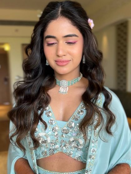 Eyes closed to showcase the delicate and pretty pink eyeshadow for her Haldi look.