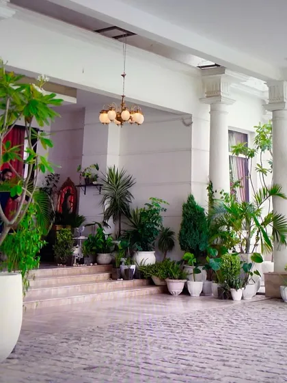A wide view of the grand porch we styled for the show. I used a variety of plants in different sizes and classic white pots to create a welcoming and luxurious feel.