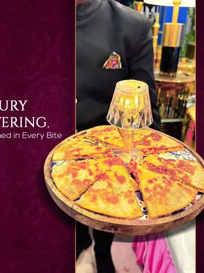 Luxury catering, redefined in every bite. A server presents a creatively served quesadilla, highlighting our innovative approach to presentation and our commitment to elevating every dish.