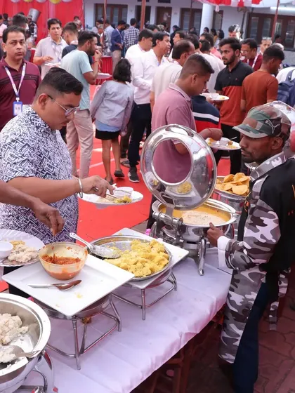 A bustling buffet line at a corporate event. Our staff is trained to manage large crowds efficiently, keeping the line moving and the food fresh.