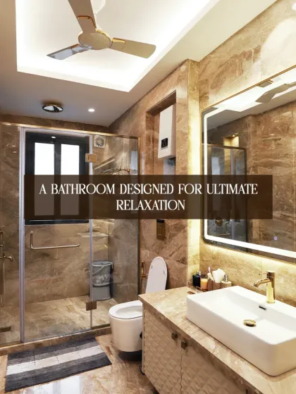 This bathroom is designed for ultimate relaxation. The warm-toned marble, glass shower enclosure, and backlit mirror create a space that is both functional and serene.