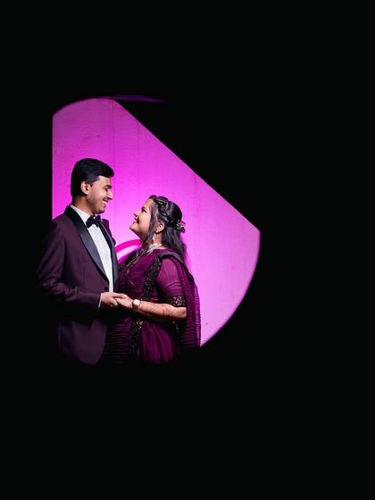 A unique, framed composition using negative space. This artistic shot creates a feeling of looking in on a private, happy moment between the couple.