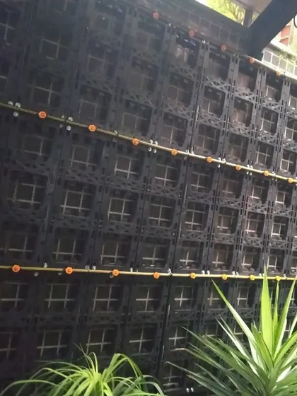 This is the framework we use to build our vertical gardens. The modular panels hold the plants and soil, and we integrate a drip irrigation system to ensure easy, automated watering.