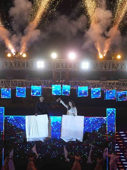 A unique Sangeet entry concept where the couple is revealed from behind large books, symbolizing the start of their new chapter together. It's all about creative storytelling.