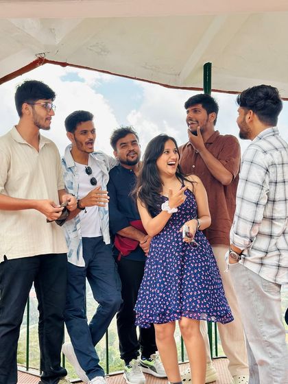 Candid moments of laughter and conversation between new friends at a viewpoint.