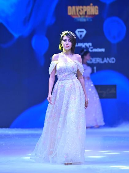 The front view of this shimmering GULFAM gown, showcasing its delicate off-shoulder design and flowing A-line skirt.