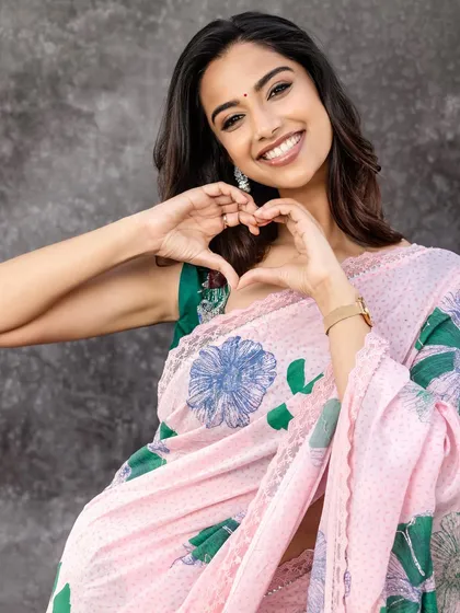 A heartwarming shot where the model makes a heart gesture. This adds a layer of personality and connection, making the fashion feel more relatable and human.