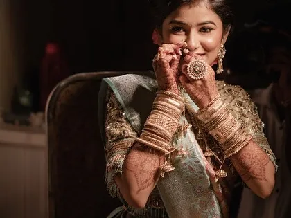 The final touches on the engagement look. The bride is ready to shine with her beautiful 'nath' and flawless makeup.