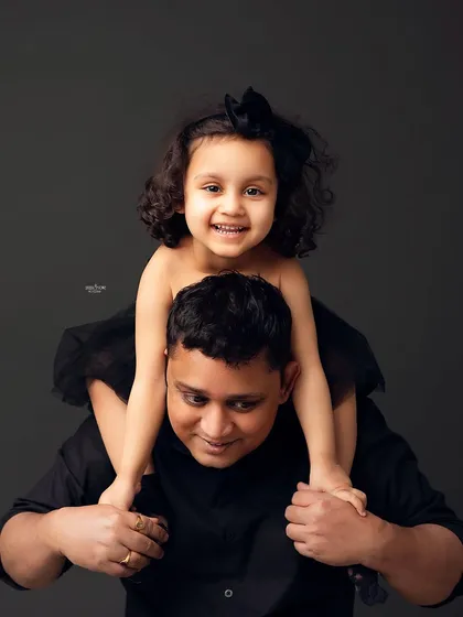 Piggyback rides from dad are the best! This fun and energetic shot perfectly captures the playful relationship between a father and his daughter.
