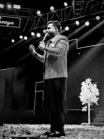 A classic black and white shot of me on stage. It captures the timeless art of hosting and the emotion I put into every performance.