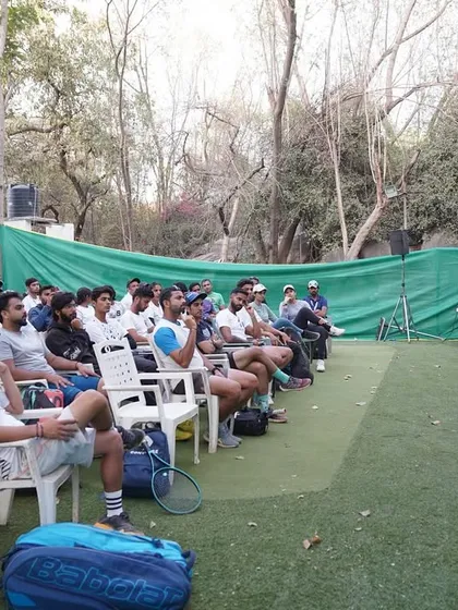 Addressing the attendees of the tennis coaching certification program. It's vital for coaches to understand the principles of biomechanics and conditioning to help their players stay healthy and perform at their best.
