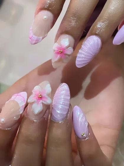 Another angle of the detailed 3D lavender shell and flower nail art, showing the texture and craftsmanship involved in each nail.