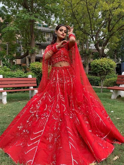 A stunning red lehenga with unique silver embroidery, perfect for making a statement at any event.