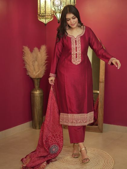This maroon silk suit set with delicate embroidery is a timeless and elegant choice for any festive occasion or wedding event.