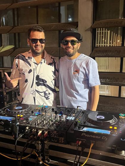 With a fellow DJ at a gig. I love collaborating with and supporting other artists in the music community.